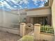 Inviting front entrance with a charming gate and tiled walkway to a covered porch at 9369 Villa Ridge Dr, Las Vegas, NV 89134