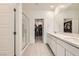 Bright bathroom showcasing double sinks, modern fixtures, and access to a walk-in closet at 9698 Pacific Pine St, Las Vegas, NV 89143