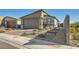 Charming single-story home featuring a two-car garage, desert landscaping, and a walkway to a private entry at 9698 Pacific Pine St, Las Vegas, NV 89143