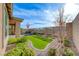 Landscaped backyard features a small lawn, desert landscaping and stone perimeter at 12397 Foxtail Run Ave, Las Vegas, NV 89138