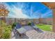 Outdoor seating area with a stone fireplace and desert landscaping at 12397 Foxtail Run Ave, Las Vegas, NV 89138