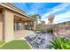 Covered backyard patio includes brick pavers, lounge chairs, and desert landscaping at 12397 Foxtail Run Ave, Las Vegas, NV 89138
