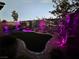 Backyard at dusk with colorfully illuminated landscaping at 12397 Foxtail Run Ave, Las Vegas, NV 89138