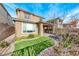 View of the landscaped backyard featuring artificial turf and a covered patio at 12397 Foxtail Run Ave, Las Vegas, NV 89138