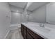 This bathroom features a double sink vanity and a bathtub/shower combo at 12397 Foxtail Run Ave, Las Vegas, NV 89138