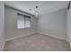 This neutral bedroom features a window with blinds and a stylish chandelier at 12397 Foxtail Run Ave, Las Vegas, NV 89138