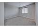 This spacious bedroom offers a window for natural light and neutral carpet at 12397 Foxtail Run Ave, Las Vegas, NV 89138