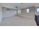 Upstairs bonus room with plush carpeting, fan, and multiple windows at 12397 Foxtail Run Ave, Las Vegas, NV 89138