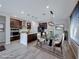 Bright dining area with tile floors, a modern light fixture and view into the kitchen at 12397 Foxtail Run Ave, Las Vegas, NV 89138