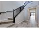 Entryway with view into the house featuring wood-look tile flooring and a carpeted staircase at 12397 Foxtail Run Ave, Las Vegas, NV 89138