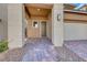 Covered front entry features brick pavers and neutral stucco exterior at 12397 Foxtail Run Ave, Las Vegas, NV 89138