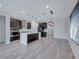Bright kitchen featuring stainless steel appliances, a large island, and modern pendant lighting at 12397 Foxtail Run Ave, Las Vegas, NV 89138