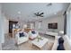 Open concept living room with tile floors, recessed lights, ceiling fan and view into kitchen and dining room at 12397 Foxtail Run Ave, Las Vegas, NV 89138