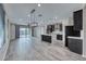 Open living room with tile floors, dark cabinetry and a large island with a white countertop at 12397 Foxtail Run Ave, Las Vegas, NV 89138