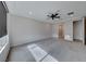 An empty main bedroom featuring carpeted floors, a ceiling fan, and access to the main bathroom at 12397 Foxtail Run Ave, Las Vegas, NV 89138