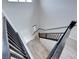 Modern staircase with dark railings and a combination of wood and carpeted steps at 12397 Foxtail Run Ave, Las Vegas, NV 89138