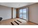 Bedroom with city views from balcony access features neutral paint and hardwood floors at 200 W Sahara Ave # 3009, Las Vegas, NV 89102