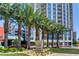 Beautiful high-rise building exterior with professional landscaping and manicured lawn, with mature palms in Las Vegas at 200 W Sahara Ave # 3009, Las Vegas, NV 89102