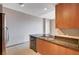 Kitchen includes stainless steel refrigerator, dishwasher, sink, granite countertops and tile floors at 200 W Sahara Ave # 3009, Las Vegas, NV 89102