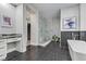 Elegant bathroom with a glass shower, modern tub, and sophisticated marble accents throughout at 2080 Orchard Mist St, Las Vegas, NV 89135