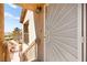 Close-up of front door with security screen and exterior wall at 2110 Los Feliz St # 2075, Las Vegas, NV 89156