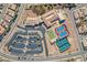 An aerial view shows a community center, parking, tennis, and bocce ball courts at 2386 Amana Dr, Henderson, NV 89044