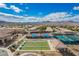 Bird's-eye view showcasing tennis courts and bocce ball in a vibrant community setting with mountain views at 2386 Amana Dr, Henderson, NV 89044
