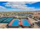 Aerial shot featuring red and blue tennis courts, landscaping, and beautiful community setting at 2386 Amana Dr, Henderson, NV 89044
