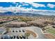 An aerial view displays the community center, parking, and well maintained bocce ball court at 2386 Amana Dr, Henderson, NV 89044