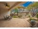 Covered patio with outdoor dining table overlooking the desert landscaped backyard at 2386 Amana Dr, Henderson, NV 89044