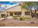 Desert landscaped backyard with covered patio and small bridge at 2386 Amana Dr, Henderson, NV 89044
