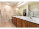 This bathroom features dual sinks, wooden cabinetry and carpet floors at 2386 Amana Dr, Henderson, NV 89044