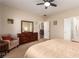 This bedroom features carpet floors, a ceiling fan and direct access to the bathroom at 2386 Amana Dr, Henderson, NV 89044