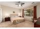 This bedroom features a ceiling fan and a large window at 2386 Amana Dr, Henderson, NV 89044