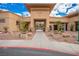 An inviting club entrance features desert landscaping, stone accents, and a covered walkway at 2386 Amana Dr, Henderson, NV 89044