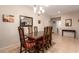 Formal dining room featuring a dark wood table, seating for six, and neutral decor at 2386 Amana Dr, Henderson, NV 89044