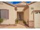 Welcoming front entrance with decorative security door, desert landscaping, and a paved walkway leading to the front door at 2386 Amana Dr, Henderson, NV 89044