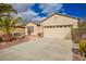 Well-maintained single-story home with desert landscaping, a concrete driveway, and an attached two-car garage at 2386 Amana Dr, Henderson, NV 89044