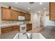 Well-lit kitchen with wooden cabinetry, tile backsplash, and modern appliances at 2386 Amana Dr, Henderson, NV 89044