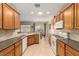 Bright kitchen boasts tile floors, wood cabinets, stone countertops and white appliances at 2386 Amana Dr, Henderson, NV 89044