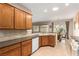 Spacious kitchen with wooden cabinetry, stone countertops, and access to the dining area at 2386 Amana Dr, Henderson, NV 89044