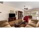 Spacious living room with tile flooring, a ceiling fan, and large windows that bring in lots of natural light at 2386 Amana Dr, Henderson, NV 89044