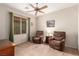 Living room with a ceiling fan, a large window, and two recliner chairs at 2386 Amana Dr, Henderson, NV 89044