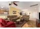 Bright living room with an open layout to the dining and kitchen areas, featuring tile flooring and cozy furniture at 2386 Amana Dr, Henderson, NV 89044