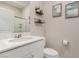 Stylish bathroom featuring sleek white vanity and decorative shelving at 2475 Piacenza Pl, Henderson, NV 89044