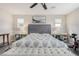 Bedroom featuring a large bed, mirrored nightstands, and a peloton bike for exercise at 2475 Piacenza Pl, Henderson, NV 89044