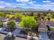 Scenic aerial view of a suburban neighborhood with lush green trees and a backdrop of majestic mountains at 2553 Showcase Dr, Las Vegas, NV 89134