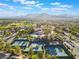 Breathtaking view of a golf community with multiple tennis courts, a pool, and mountain views in the distance at 2553 Showcase Dr, Las Vegas, NV 89134
