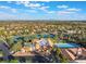 Overhead view of a community showcasing its tennis courts, pool, and landscaping, set against a mountain backdrop at 2553 Showcase Dr, Las Vegas, NV 89134