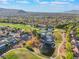 Stunning aerial view of a golf course community, featuring a serene lake and mountain views in the background at 2553 Showcase Dr, Las Vegas, NV 89134